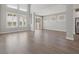 Spacious living room with hardwood floors and large windows at 1532 Gopher Loop, Tarpon Springs, FL 34689