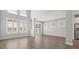 Spacious living room with hardwood floors and large windows at 1532 Gopher Loop, Tarpon Springs, FL 34689