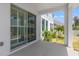 Covered patio with sliding glass doors and access to backyard at 1532 Gopher Loop, Tarpon Springs, FL 34689