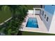 Modern rectangular pool surrounded by tropical landscaping, creating a private backyard oasis at 1532 Gopher Loop, Tarpon Springs, FL 34689