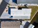 Aerial view of a single-wide home with metal roof and paved driveway at 162 S Saint Thomas Cir, Apollo Beach, FL 33572