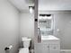 Updated bathroom with white vanity, toilet and gray accents at 162 S Saint Thomas Cir, Apollo Beach, FL 33572