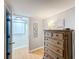 Bedroom with dresser and view of adjacent room at 162 S Saint Thomas Cir, Apollo Beach, FL 33572