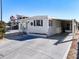White single-wide home with carport and paved driveway at 162 S Saint Thomas Cir, Apollo Beach, FL 33572