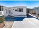 White single-wide home with carport and landscaped yard at 162 S Saint Thomas Cir, Apollo Beach, FL 33572