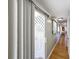 Long hallway with light wood floors and access to rooms at 162 S Saint Thomas Cir, Apollo Beach, FL 33572