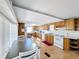 Kitchen with wood cabinets, white appliances, and laminate flooring at 162 S Saint Thomas Cir, Apollo Beach, FL 33572