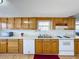 Kitchen features wood cabinets, white appliances, and laminate flooring at 162 S Saint Thomas Cir, Apollo Beach, FL 33572