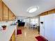 Open kitchen with wood cabinets, white appliances, and view of dining area at 162 S Saint Thomas Cir, Apollo Beach, FL 33572