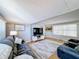 Living room with hardwood floors, sofas, and a TV at 162 S Saint Thomas Cir, Apollo Beach, FL 33572