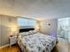 Main bedroom with king-size bed, nightstands, and en-suite bathroom at 162 S Saint Thomas Cir, Apollo Beach, FL 33572