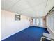 Sunroom with blue carpet and an oval door at 162 S Saint Thomas Cir, Apollo Beach, FL 33572