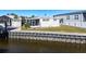 Waterfront view of a white mobile home with seawall at 162 S Saint Thomas Cir, Apollo Beach, FL 33572