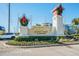 Suncoast Communities entrance sign with holiday decorations at 17227 Poppy Fields Ln, Land O Lakes, FL 34638