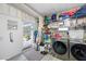 Spacious laundry room with washer, dryer, and ample storage shelving at 18675 Us Highway 19 N # 319, Clearwater, FL 33764