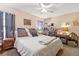 Main bedroom with king-size bed, ceiling fan, and cat tree at 2044 Sheffield Ct, Oldsmar, FL 34677