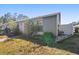 Gray house exterior with a small yard and white fence at 2044 Sheffield Ct, Oldsmar, FL 34677