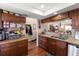Well-equipped kitchen featuring granite countertops and wood cabinets at 2044 Sheffield Ct, Oldsmar, FL 34677