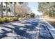 Gated community entrance with paved road and lush landscaping at 4012 Beaumont Loop, Spring Hill, FL 34604