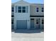 Charming townhome with a one-car garage and neutral gray paint scheme at 4588 Pleasant Ave, Palm Harbor, FL 34683