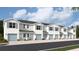 Five-unit townhome building with light blue accents and attached garages at 4588 Stargazer Ct, Palm Harbor, FL 34683