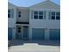 Charming townhouse with blue shutters and attached one-car garage at 4596 Pleasant Ave, Palm Harbor, FL 34683