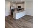 Modern kitchen featuring stainless steel appliances, white cabinets, and a center island at 4604 Pleasant Ave, Palm Harbor, FL 34683