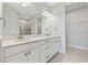 Modern bathroom with double vanity, a large mirror, and access to a walk-in closet at 5406 Rushmere Ct, Palmetto, FL 34221