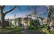 House exterior featuring a yellow door and landscaping at 6106 Hartford St, Tampa, FL 33619