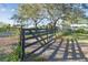 Black metal gate on chain link fence at 6106 Hartford St, Tampa, FL 33619