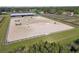 Aerial view of a sand riding arena with jumps, perfect for equestrian activities at 6106 Hartford St, Tampa, FL 33619