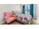 Bright bedroom with a patchwork quilt and pink armchair at 702 E Gilchrist St, Plant City, FL 33563