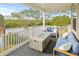 Covered deck with fire pit and seating overlooking the water at 8942 Rocky Creek Dr, Tampa, FL 33615