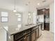 Kitchen with large island, dark cabinets, and granite counters at 925 Terra Vista St, Brandon, FL 33511