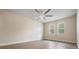 Bedroom with wood-look floors and two windows at 10800 Us 19 N. # 230, Pinellas Park, FL 33782