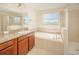 Relaxing bathroom with soaking tub, shower, and double vanity at 10836 Carloway Hills Dr, Wimauma, FL 33598