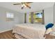 Cozy bedroom featuring wood-look floors and a ceiling fan at 11845 Carmen Ave, Dade City, FL 33525