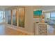 Neutral-toned hallway with tasteful artwork and a view into the living room at 1200 Gulf Blvd # 1104, Clearwater Beach, FL 33767