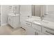 White double sink bathroom with modern fixtures, granite countertops, and updated cabinetry at 12170 Meditation Trl, Venice, FL 34293