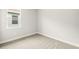 This bedroom features neutral carpeting and a window that allows natural light at 12170 Meditation Trl, Venice, FL 34293
