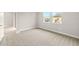 Cozy bedroom featuring neutral carpet and access to hallway at 12170 Meditation Trl, Venice, FL 34293