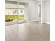 An indoor/outdoor living space featuring large sliding doors and tile flooring at 12170 Meditation Trl, Venice, FL 34293