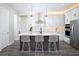 Modern kitchen with an island, stainless steel appliances, and white cabinets at 12205 Meditation Trl, Venice, FL 34293