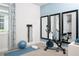 Home gym with exercise bike, yoga mat, and weights at 12236 Meditation Trl, Venice, FL 34293