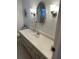 Bathroom vanity featuring a mirror, lighting, and a clean countertop at 13225 101St St # 451, Largo, FL 33773