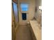 This cozy bathroom features a tub with sliding shower door, tile flooring, and a sink with cabinet storage at 13225 101St St # 451, Largo, FL 33773