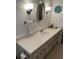 Bathroom vanity featuring a stylish mirror, lighting, and ample storage at 13225 101St St # 451, Largo, FL 33773