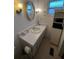 This cozy bathroom features a white sink with cabinet storage, mirrored medicine cabinet, and tile floors at 13225 101St St # 451, Largo, FL 33773
