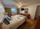 This cozy bedroom features light hardwood floors, closet with sliding doors, and a dresser with mirror at 13225 101St St # 451, Largo, FL 33773