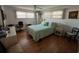 Well-lit bedroom with wood-look floors, ceiling fan, and two windows at 13225 101St St # 451, Largo, FL 33773